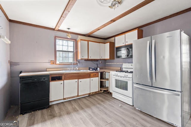 kitchen with beamed ceiling, light wood-type flooring, light countertops, black appliances, and a sink