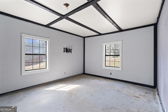 carpeted spare room featuring plenty of natural light, beamed ceiling, coffered ceiling, and baseboards