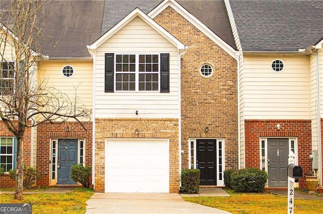 townhome / multi-family property featuring brick siding, an attached garage, driveway, and roof with shingles