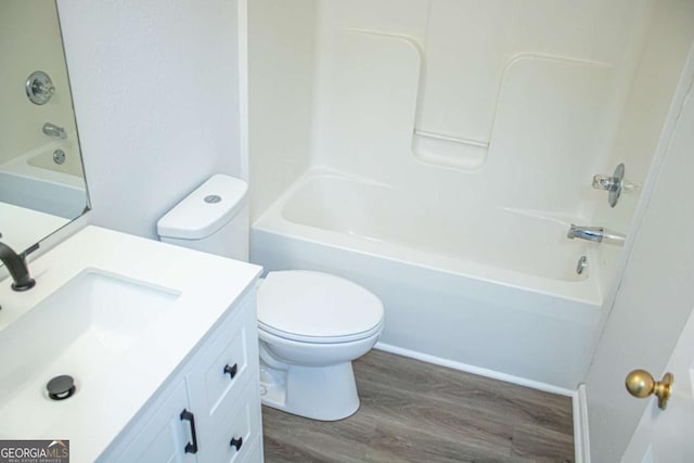 bathroom featuring vanity, toilet, shower / bath combination, and wood finished floors