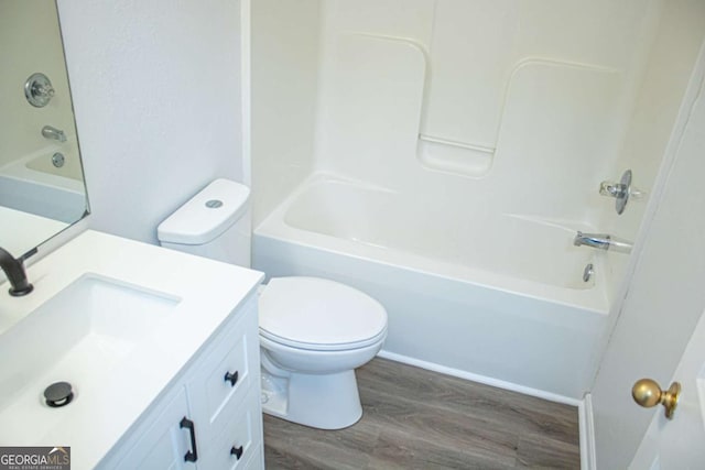 full bathroom with vanity, toilet, wood finished floors, and bathtub / shower combination