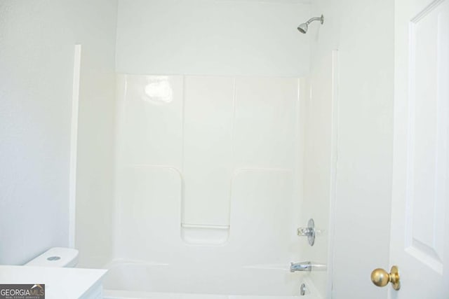 bathroom with shower / bathing tub combination, toilet, and vanity