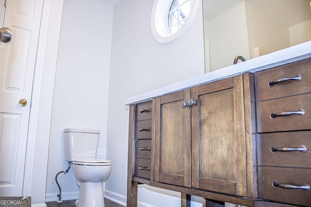 bathroom with toilet and baseboards