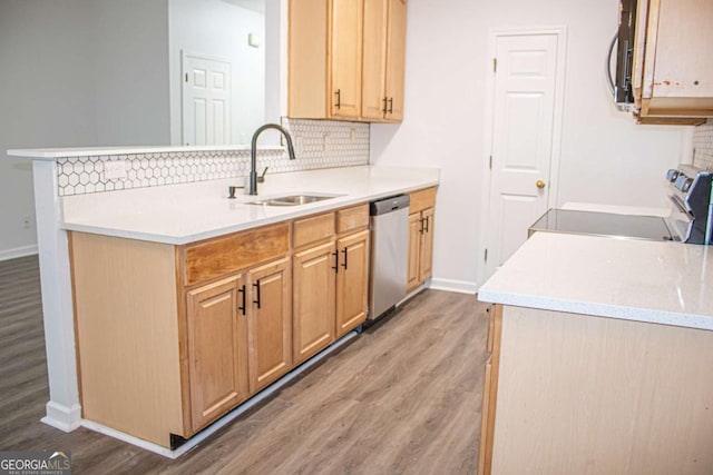 kitchen with light wood-style flooring, a sink, stainless steel appliances, light countertops, and backsplash