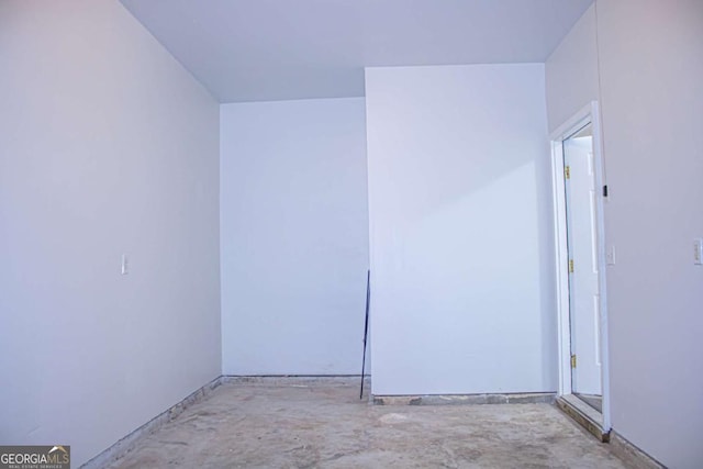 unfurnished room featuring concrete flooring