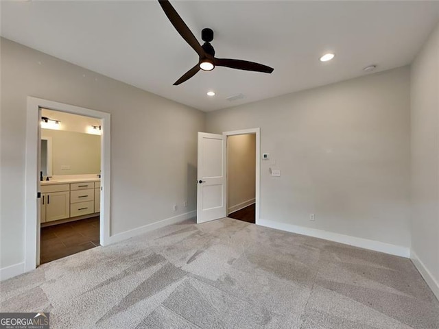 unfurnished bedroom featuring recessed lighting, baseboards, carpet floors, and ensuite bath