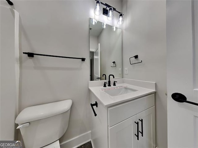 bathroom featuring toilet and vanity