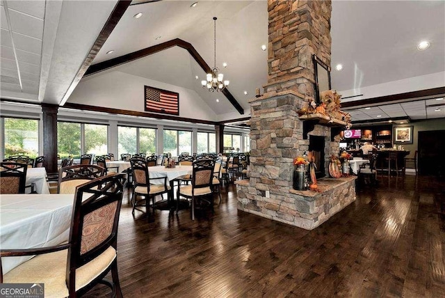 dining room with an inviting chandelier, wood finished floors, ornate columns, and high vaulted ceiling