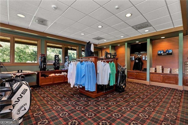 miscellaneous room featuring recessed lighting, dark colored carpet, and a drop ceiling