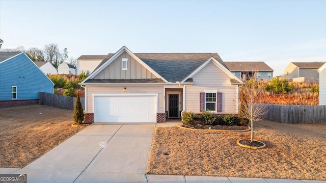 view of front of house with fence, concrete driveway, a garage, board and batten siding, and brick siding