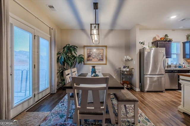 dining room with wood finished floors and visible vents