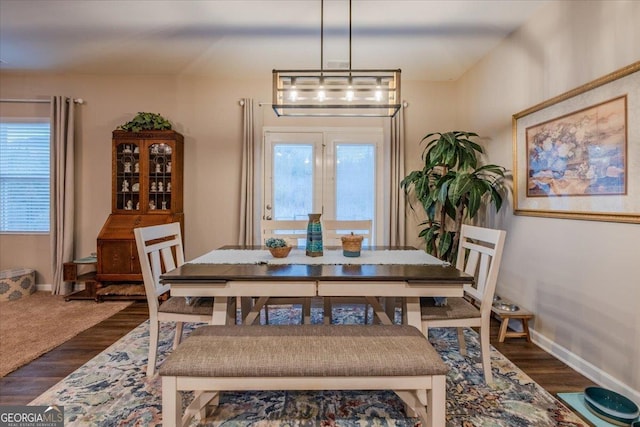 dining room with dark wood-style floors and baseboards