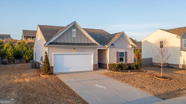 view of front facade with central AC, concrete driveway, a garage, board and batten siding, and brick siding