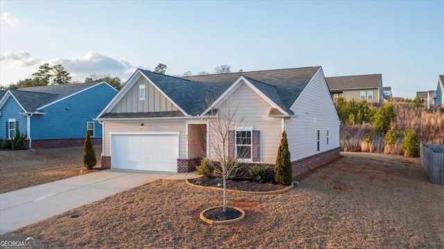 view of front facade with concrete driveway, an attached garage, brick siding, and board and batten siding