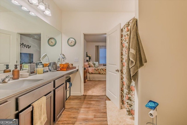 full bathroom featuring vanity, ensuite bathroom, and wood finished floors