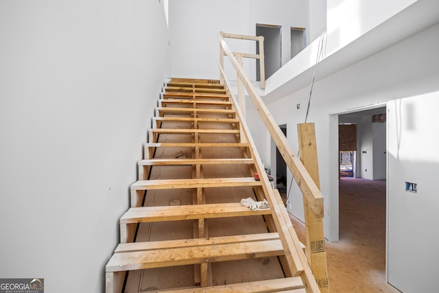 staircase with a high ceiling