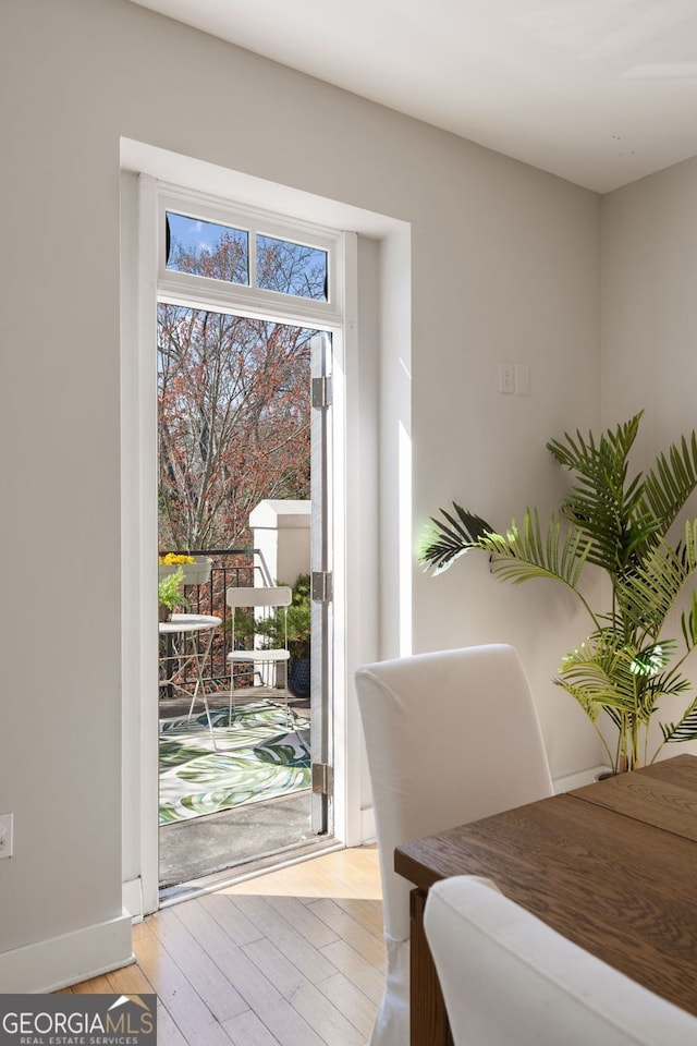 dining area with light wood-style flooring and baseboards