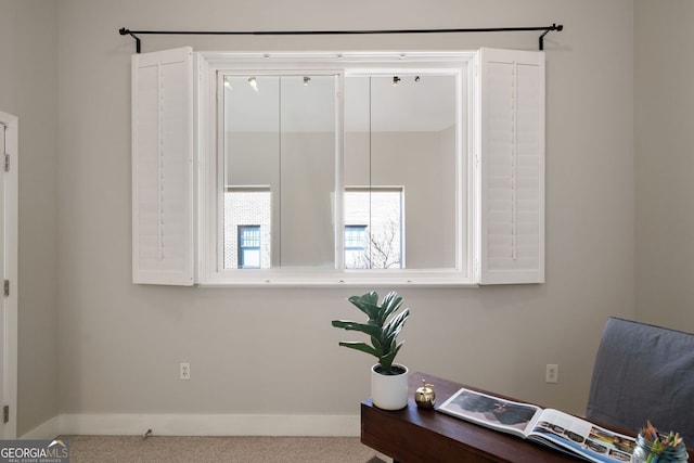 carpeted office space featuring baseboards