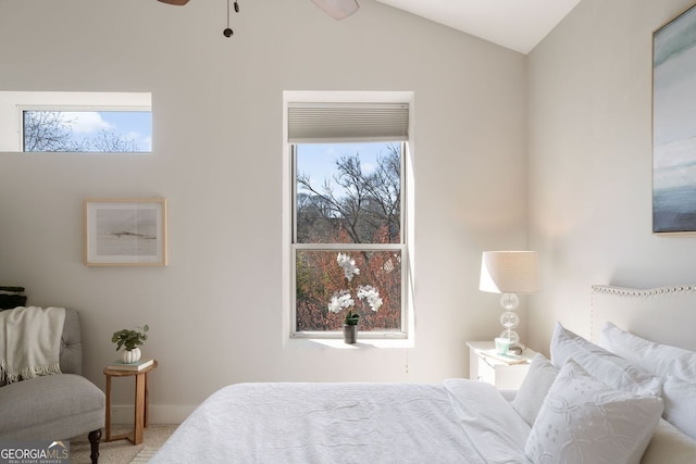 carpeted bedroom with multiple windows and lofted ceiling