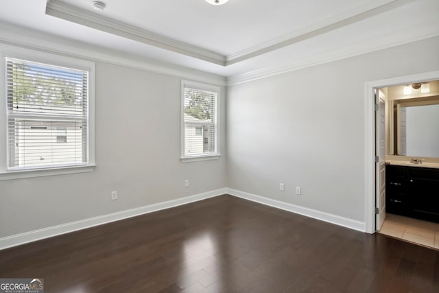 unfurnished bedroom with baseboards, wood finished floors, and ornamental molding