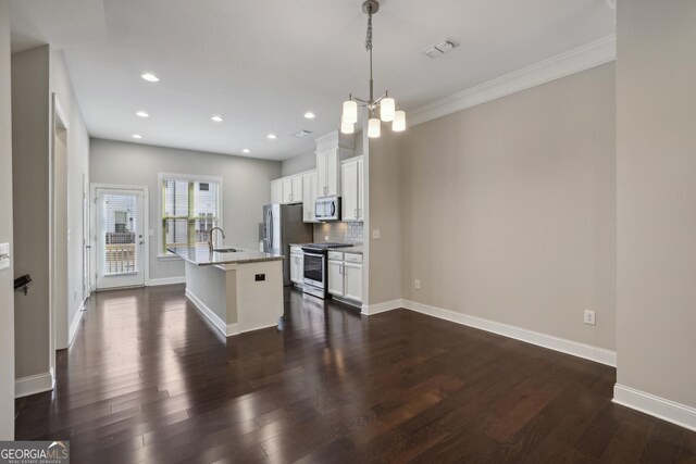 kitchen with a sink, white cabinets, dark wood-style floors, and stainless steel appliances