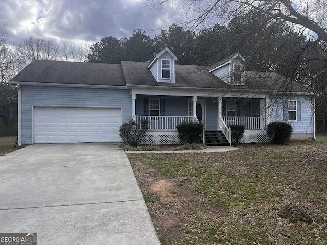 new england style home with covered porch, concrete driveway, and a garage