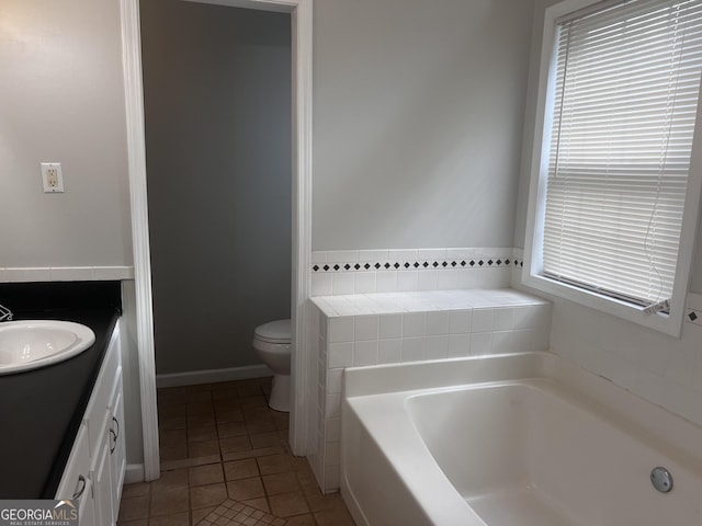 full bath with tile patterned flooring, toilet, vanity, and a garden tub