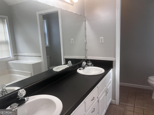 full bath with tile patterned flooring, toilet, and a sink