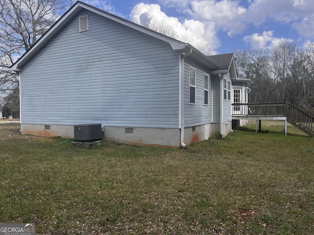 view of home's exterior with a yard, central AC unit, and crawl space