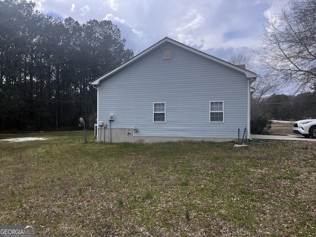 view of side of home featuring a yard