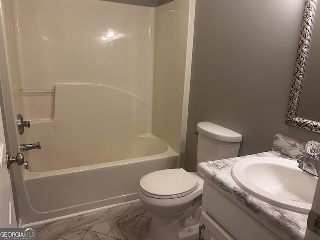 full bath with marble finish floor, toilet, vanity, and bathing tub / shower combination