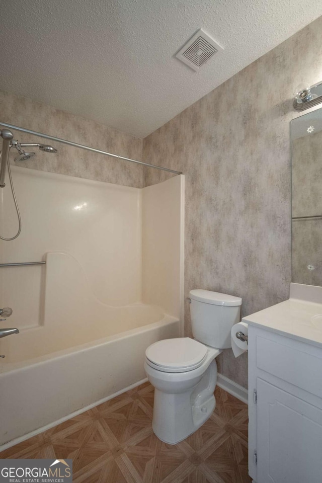 bathroom featuring visible vents, toilet, a textured ceiling, shower / bath combination, and vanity