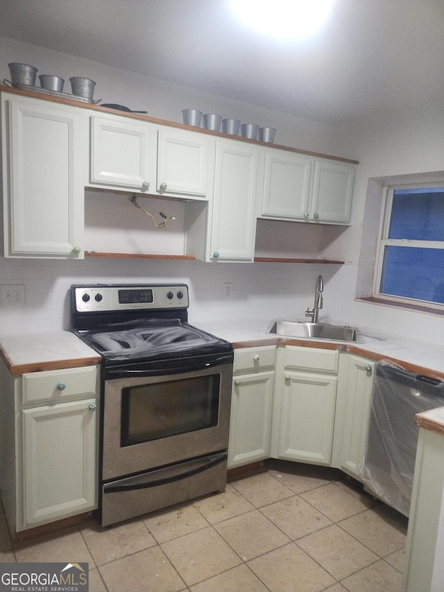 kitchen featuring light countertops, tasteful backsplash, appliances with stainless steel finishes, and a sink