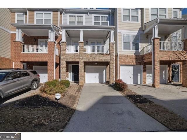 townhome / multi-family property featuring driveway and an attached garage