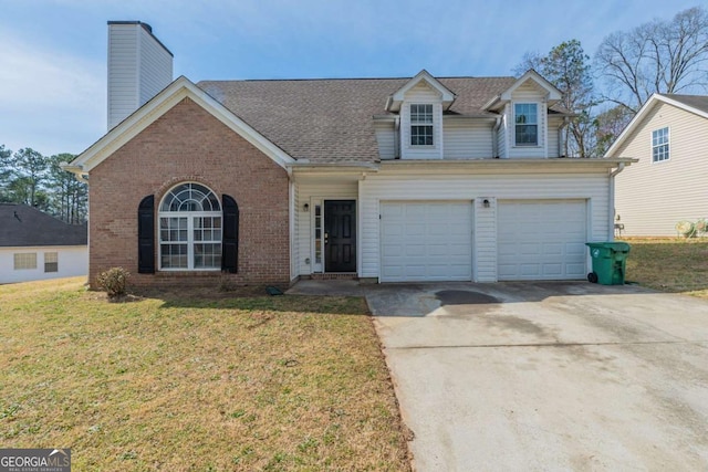 view of front of property with a front lawn, brick siding, a chimney, and driveway