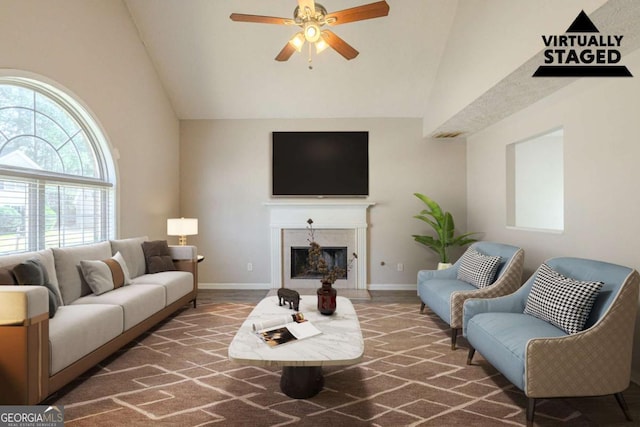 carpeted living room with high vaulted ceiling, a fireplace, baseboards, and ceiling fan