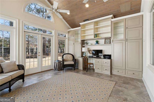 office with a healthy amount of sunlight, french doors, built in study area, and ceiling fan