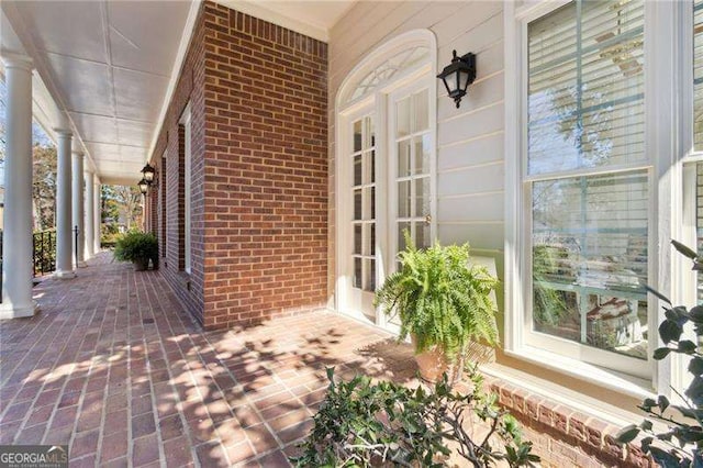 view of patio featuring french doors and a porch