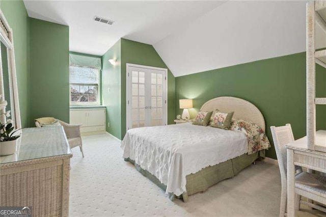 bedroom featuring visible vents, baseboards, lofted ceiling, carpet floors, and french doors