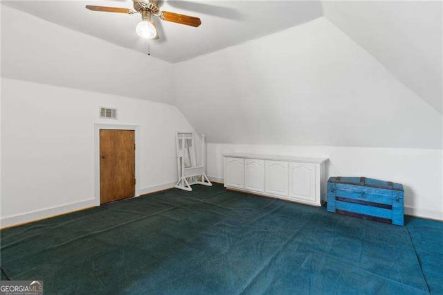 bonus room featuring baseboards, visible vents, ceiling fan, vaulted ceiling, and dark carpet