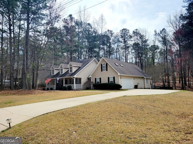 view of front facade featuring a garage, driveway, and a front lawn