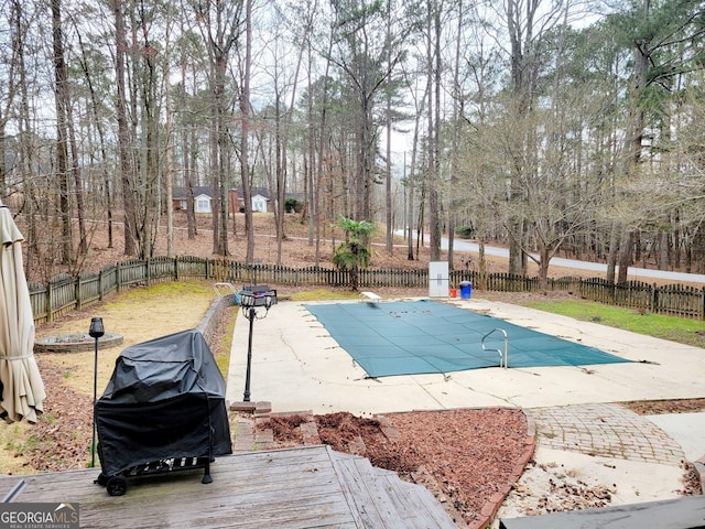 view of pool featuring a fenced in pool, a patio, area for grilling, and a fenced backyard