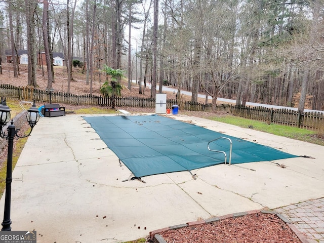 view of swimming pool featuring a fenced in pool, a fenced backyard, and a patio area