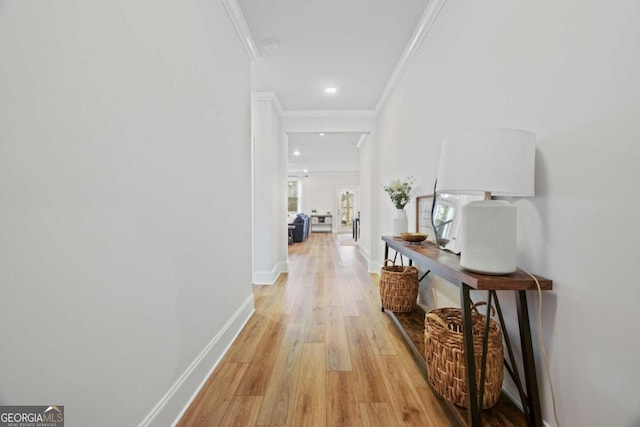 corridor featuring recessed lighting, light wood-style floors, baseboards, and ornamental molding