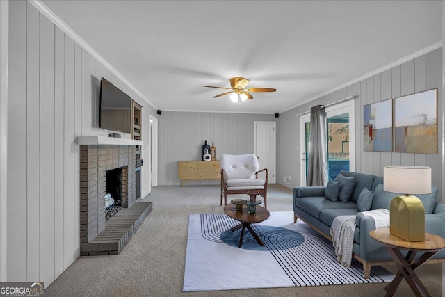 carpeted living room featuring ceiling fan, a brick fireplace, and ornamental molding