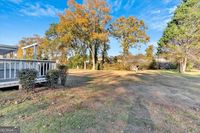 view of yard featuring a wooden deck