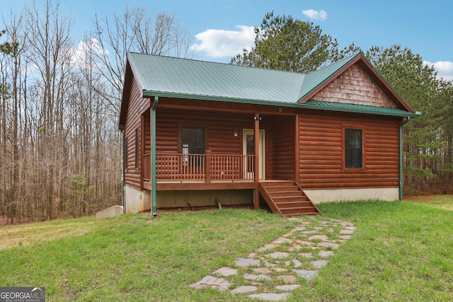 log cabin featuring covered porch, a front lawn, and log veneer siding