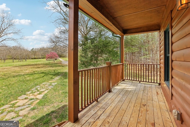 wooden terrace with a yard