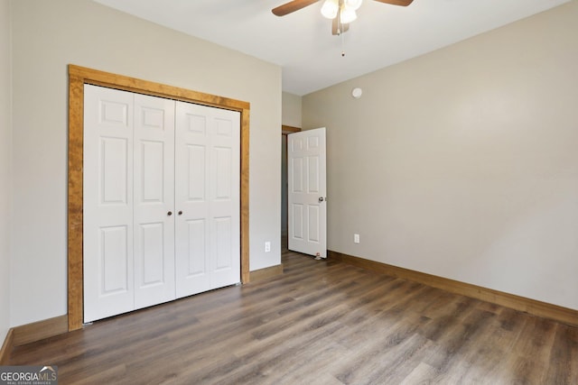 unfurnished bedroom with wood finished floors, baseboards, a closet, and ceiling fan