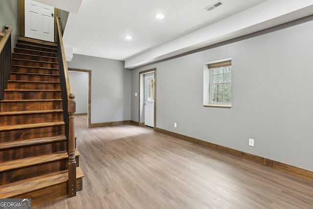 interior space featuring baseboards, visible vents, recessed lighting, stairs, and light wood-type flooring